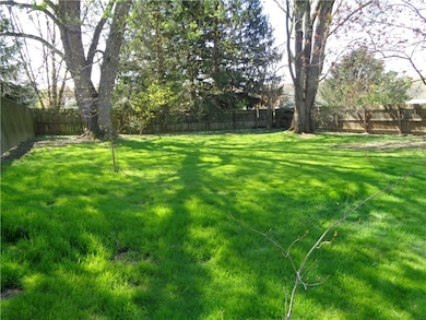 Tree lined  large flat private fenced in rear yard