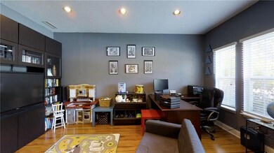 Office Den Bonus Room.  Entertainment Center remains. Wooden stlye floors.  Could be converted to a 6th bedroom on main floor.