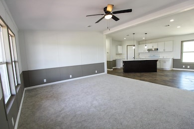 Unfurnished living room featuring dark colored ca