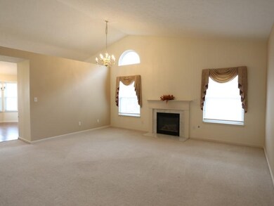 Family Room. The spacious family room features a gas fireplace, and vaulted ceilings.