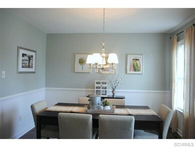 Formal dining offers chair rail, lovely chandelier