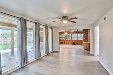 Empty room with ceiling fan and light hardwood / w