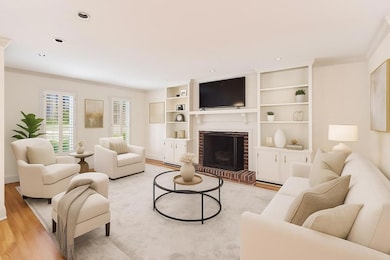 Light-Filled Family Room With A Fireplace Flanked By Built-Ins