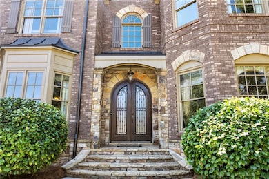 A grand entryway welcomes you with stately double doors, hinting at the elegance within