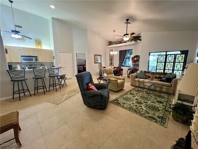 Living room with ceiling fan with notable chandeli