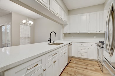 The kitchen has been recently updated and feels fresh and modern, featuring new cabinetry that offers plenty of storage space. The layout keeps you connected to the living and dining areas, making it easy to cook, entertain, or chat with guests without missing a beat.