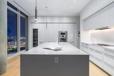 Kitchen featuring white cabinets, sink, hanging li