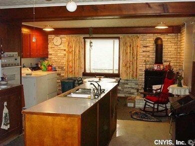 Kitchen. Large island has sink and dishwasher. Was