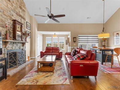 Living area with visible vents, high vaulted ceili