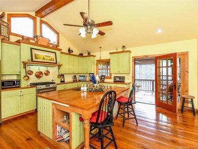 The cheerful sunlit kitchen offers extensive room 