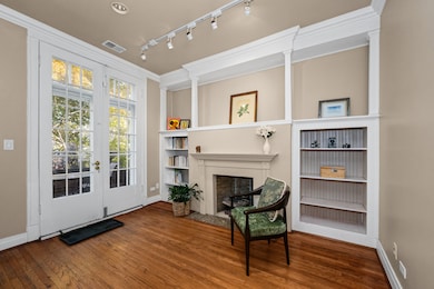 Fireplace and French doors lead to private outdoor