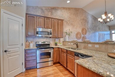 Kitchen featuring light stone countertops, sink, s