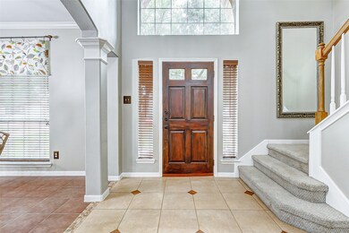 A two-story entrance invites you into the home wit