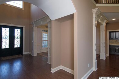 Grand entry showcases the dining room, great room, open hallway above, plus a lighted alcove.