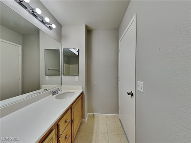 Bathroom with vanity and light tile patterned floors