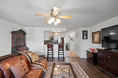 Living room with a textured ceiling, hardwood / wo