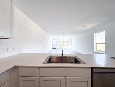 kitchen opens to a bright and open living space