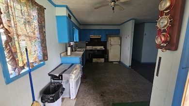 Kitchen featuring freestanding refrigerator, blue 