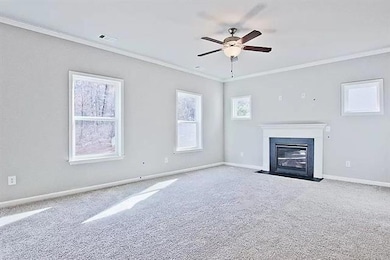 Unfurnished living room featuring ornamental moldi