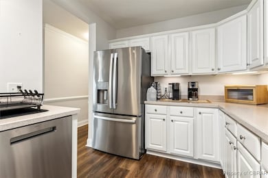 Kitchen featuring white cabinets, stainless steel