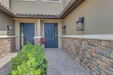 Entrance to property featuring stone siding and st