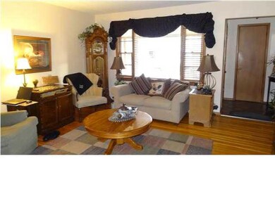 The livingroom is warm and inviting with hardwood 