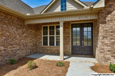 lovely front covered porch with I foot french doors says welcome home.