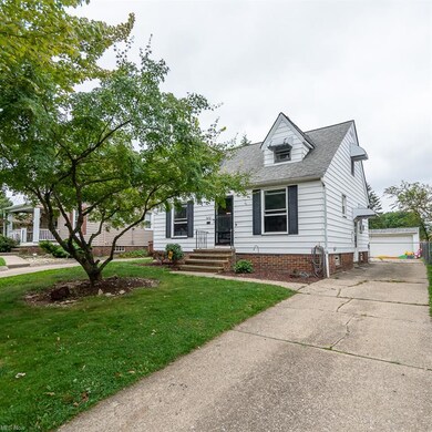 New england style home with garage and a front lawn