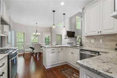 Kitchen featuring an inviting chandelier, a sink, 