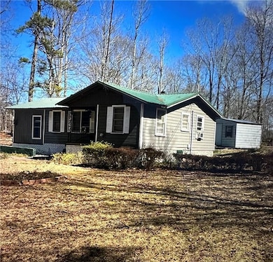 View of property exterior with a metal roof