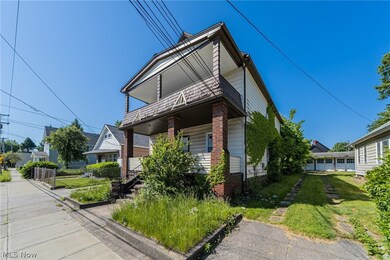 View of front of property featuring a front yard and a garage