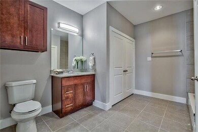 Bathroom with tile patterned flooring, vanity, a b