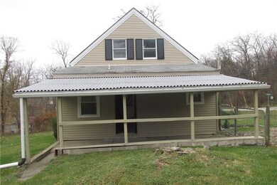 Side view of the home, showing the covered car por