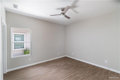 Spare room featuring a ceiling fan and wood finished floors