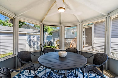 Sunroom / solarium featuring ceiling fan and outdoor dining area