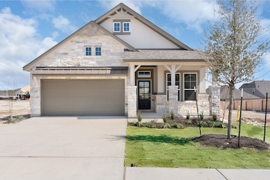 View of front facade featuring stucco siding, cov