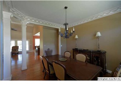 Large dining room is accented with columns, custom