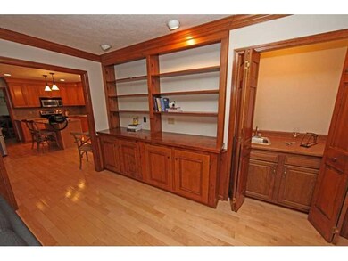 Family Room. Great wall of built ins and wet bar i