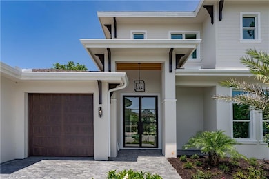 Entrance to property featuring stucco siding and driveway