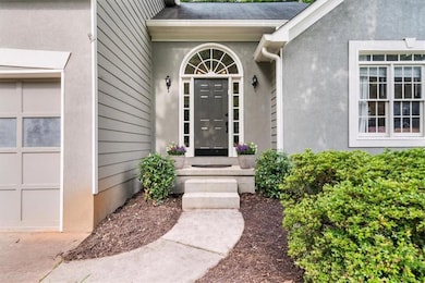 View of exterior entry with stucco siding