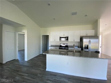 Kitchen with white cabinetry, a center island with