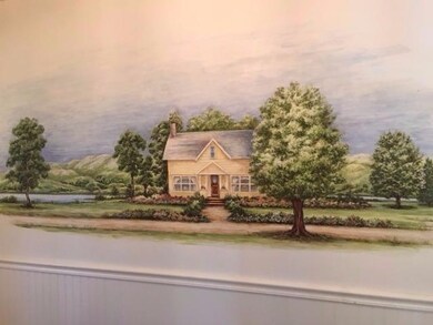 Hand painted mural covers the front entry wall.