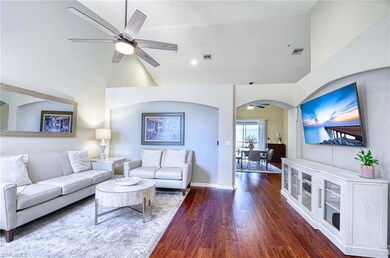 Living room featuring a ceiling fan, arched walkwa