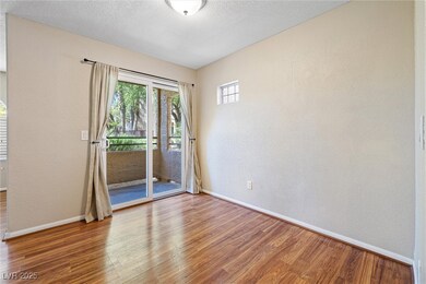 Empty room featuring wood finished floors, a textu