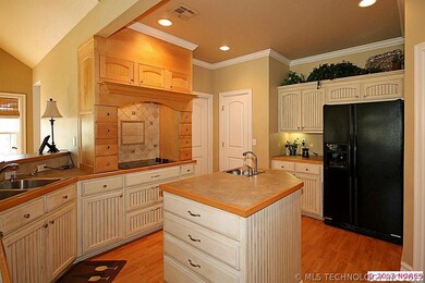 Kitchen has antiqued cabinets and center island wi