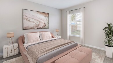 Bedroom featuring light colored carpet and baseboa