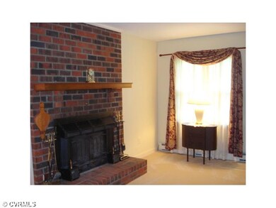 Living Room - Brick Fireplace with wood stove inse