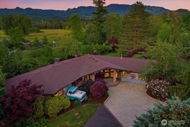 Gated estate nestled on nearly 7 acres of park-like grounds in the heart of Enumclaw.