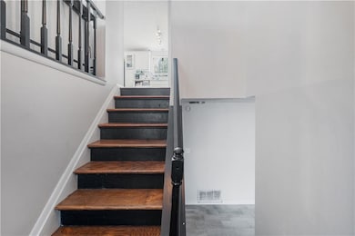 Stairway featuring baseboards and visible vents