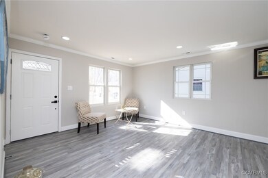 Unfurnished room with crown molding and wood-type